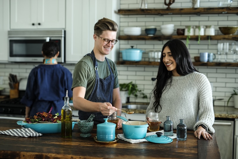 A jar of homemade granola next to a handwritten savings goal notebook in a bright kitchen.